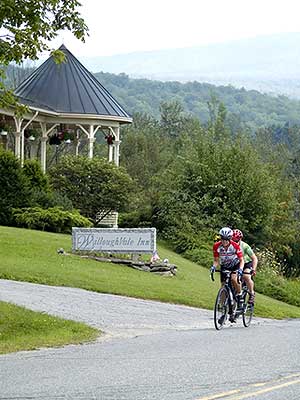Cyclists pass the Willoughvale Inn on Lake Willoughy during Velo Quebec's tour of Northern Vermont